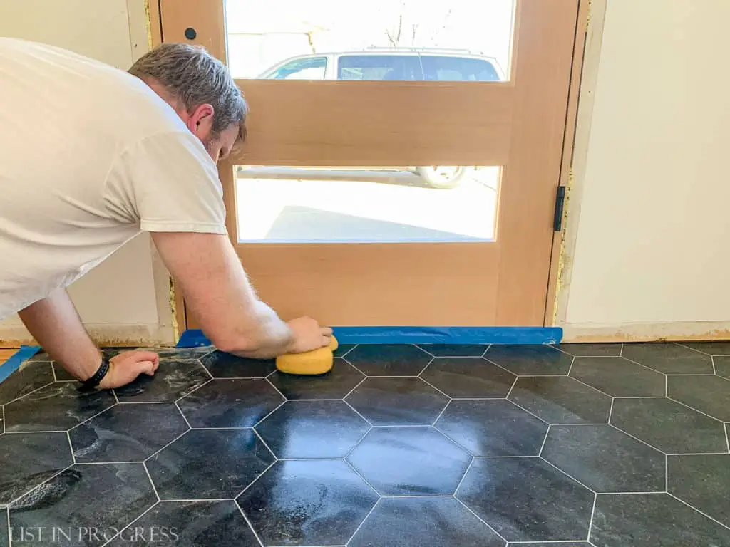 cleaning up grout with sponge