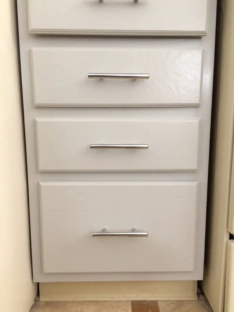 stainless steel bar pulls on gray painted cabinets